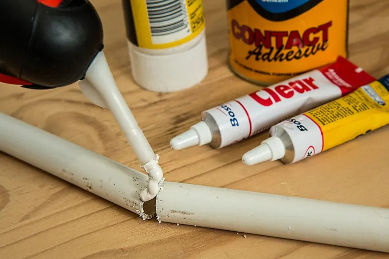 Colored silicone caulk photographed on a workshop bench