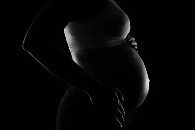 Silicone belly photographed on a vanity shelf beside a mirror