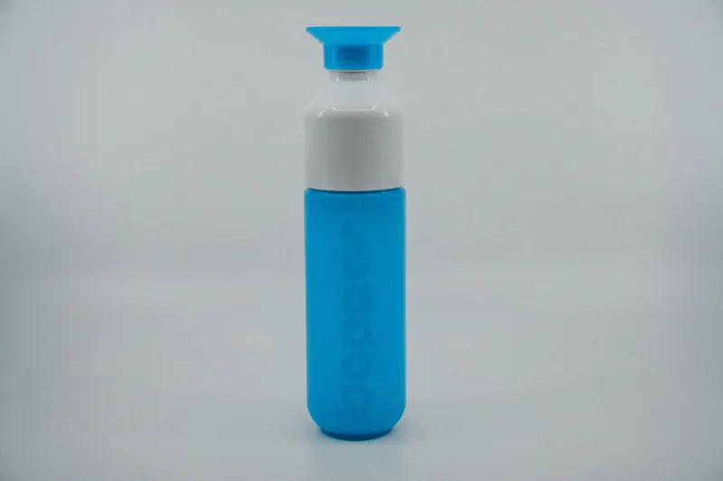 Silicone bottles photographed on a wooden kitchen countertop