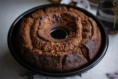Silicone round cake pan photographed on a wooden kitchen countertop