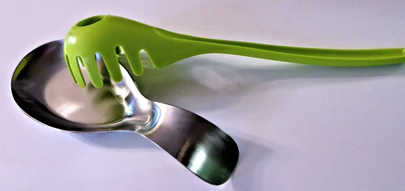 Silicone spoon rest photographed on a wooden kitchen countertop