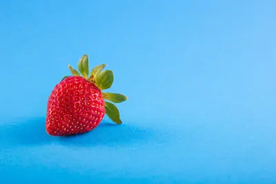 Strawberry silicone mold photographed on a wooden kitchen countertop